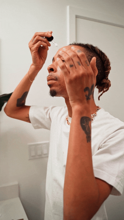 Male using facial oils 